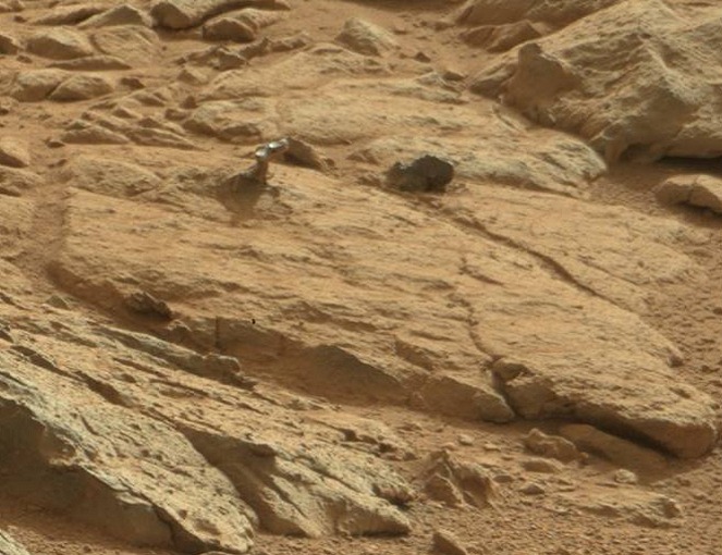 Загадочный "металический" предмет торчит из каменной плиты на Марсе
